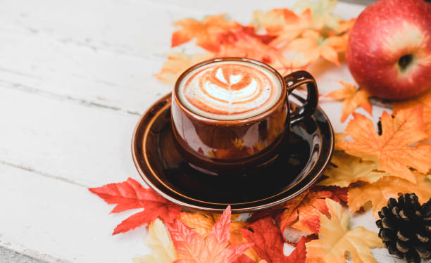 istock Autumn and Fall season. Hot coffee with fake maple leaf on wood table. Harvest cornucopia and Thanksgiving day concept. 1280280355