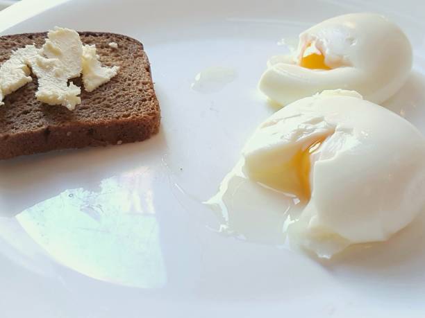 istock Breakfast: two crumpled eggs and rye bread with butter 1280281399