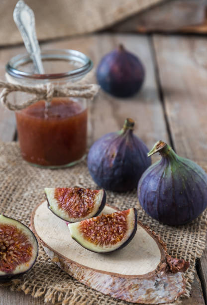 istock Fig jam in a jar on a rustic wooden table, vertical stock photo 1280281771