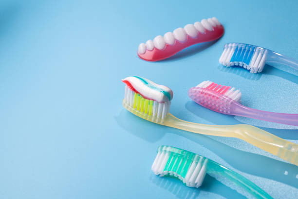 istock Closeup of blue toothbrush with toothpaste 1280282477