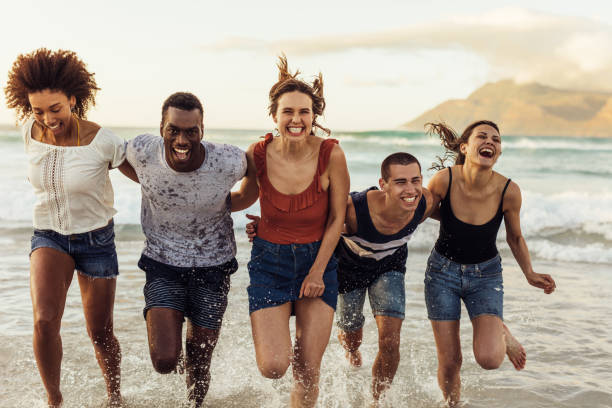 istock Group of friends having fun at the beach 1280283571