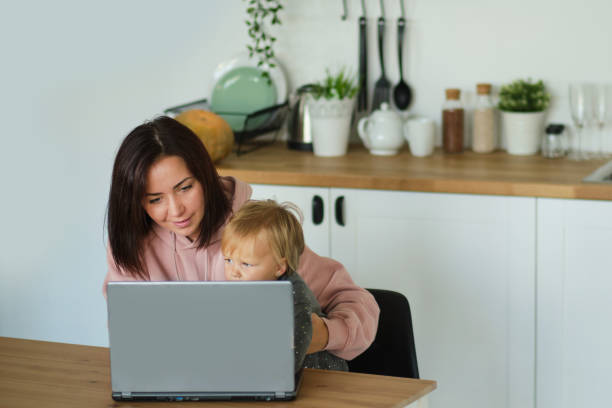 istock Working from home office with kid. Mother and daughter using laptop and Internet. Freelancer workplace. Happy woman teaching little child. Distance learning, isolation, homeschooling. Lifestyle moment 1280283669