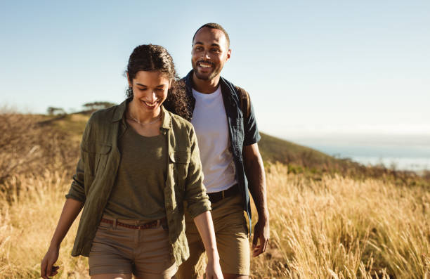 istock Happy couple hiking on a hillock 1280283757