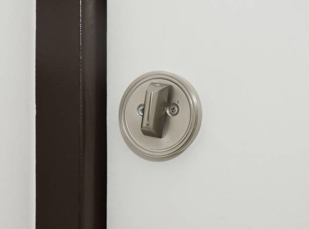 istock A close-up on a white door with round flush pull privacy kit, sliding pocket door bathroom lock. 1280286159