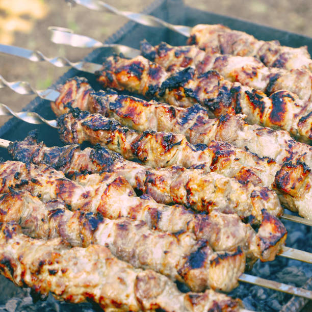 istock Roasted meat cooked at barbecue and skewers during picnic 1280286301