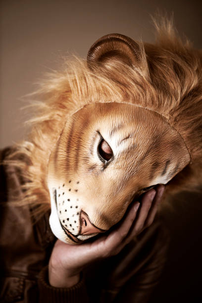 istock man wearing a lion mask 1280288158