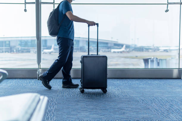 istock An Asian man with a big backpack walking in the airport 1280288832