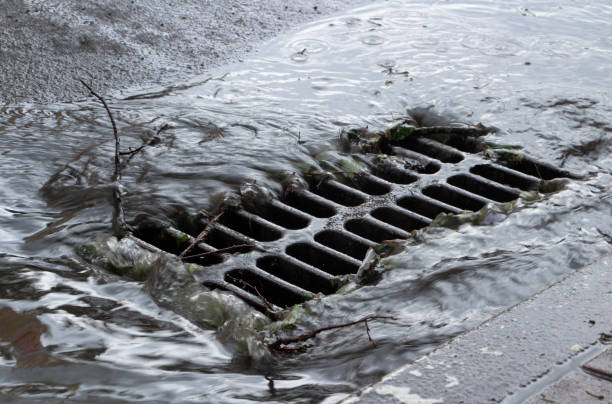 rainwater flows into a storm sewer. city sewage system. - water pipe rusty dirty equipment imagens e fotografias de stock