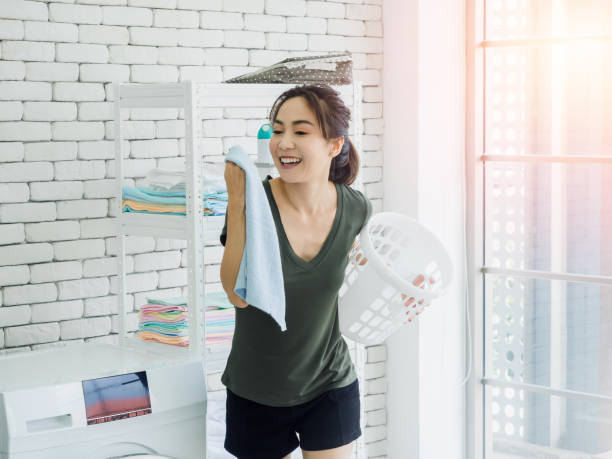 istock Asian woman in laundry room. 1280297903