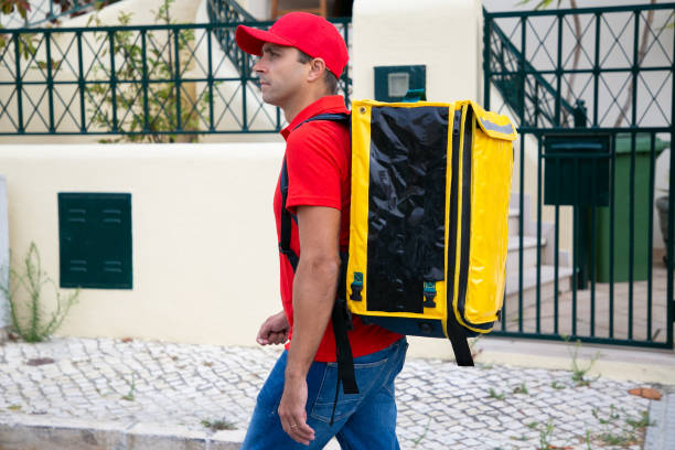 istock Concentrated courier delivering order and pacing along street 1280297920