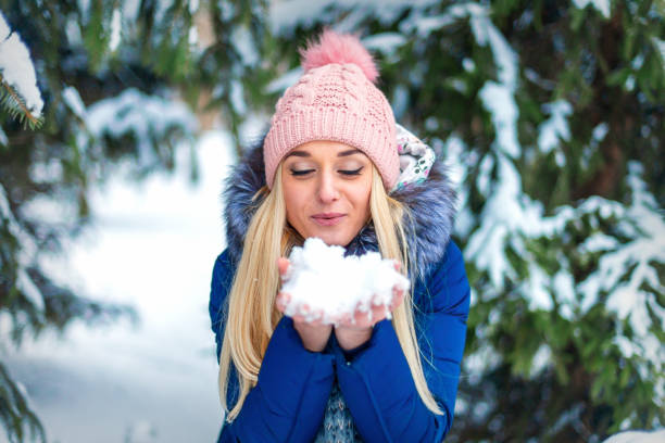 istock Woman blowing on the snow 1280300846