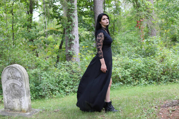 istock Spooky woman walking through abandoned cemetery 1280302946