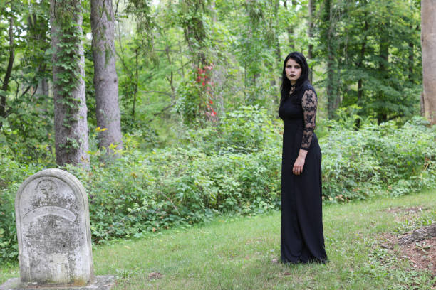 istock Spooky woman walking through abandoned cemetery 1280302958