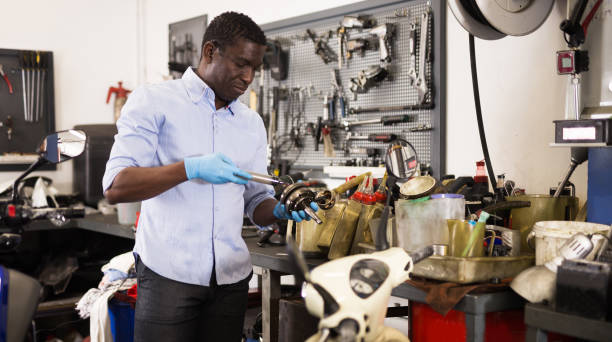 istock Confident worker examines a broken motorcycle part of the working area 1280303185
