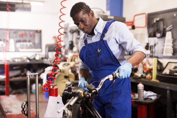 istock Service engineer repairs a motorcycle steering wheel in a motorcycle service 1280303216
