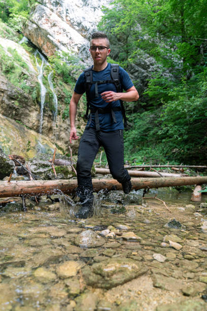 istock Young Caucasian man walking through water 1280303815
