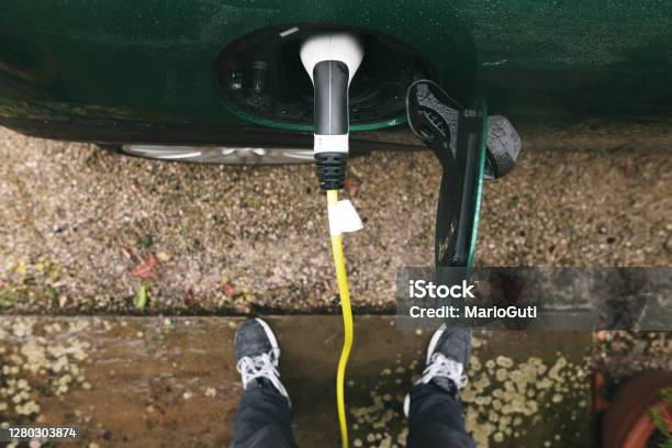 Detail Of An Electric Car Plugged In Stock Photo - Download Image Now - Electric Car, Battery, Charging