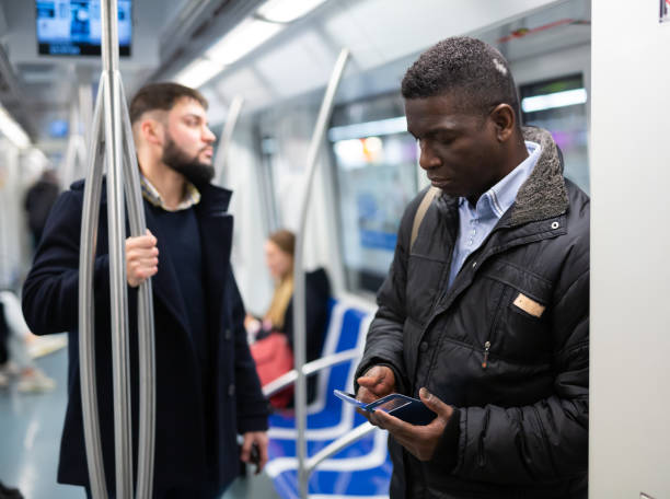 istock African American man using mobile phone in metro car 1280304641