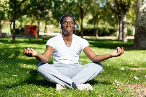 istock Athletic african  american  in headphones  sitting  before training in park 1280304657