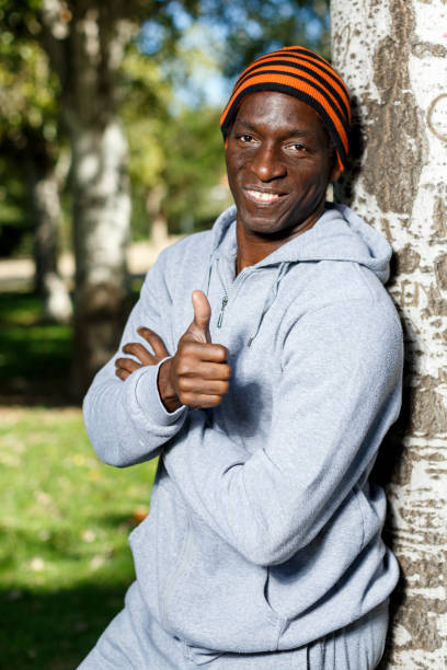 istock Athletic african  american male standing  near tree before training in park 1280304667