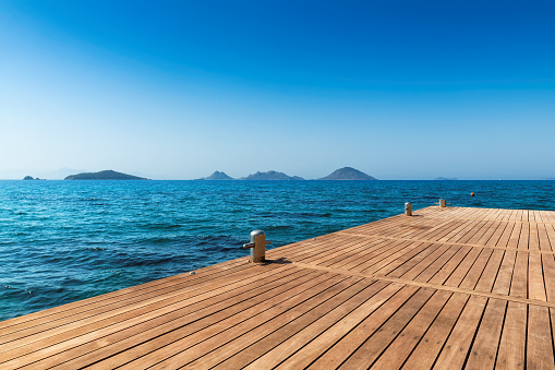 Wooden pier and beautiful sea on Mediterranean coast, Europe.