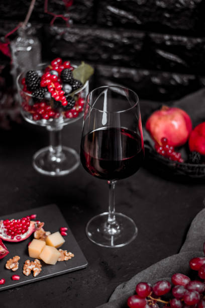 moody elegant red wine glass with fruits and cheese - raspberry table wood autumn imagens e fotografias de stock