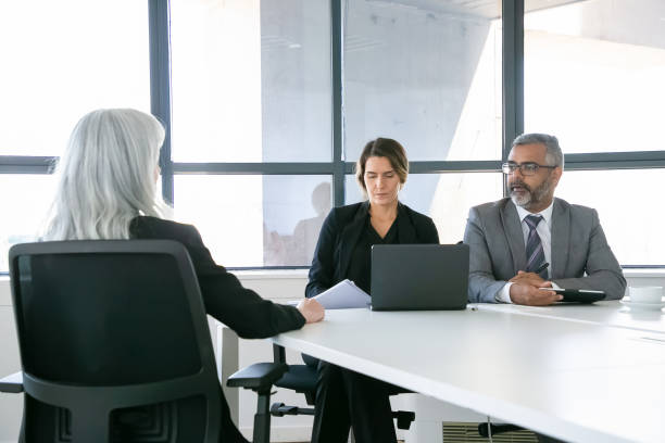 istock Serious company managers talking to job candidate 1280309247