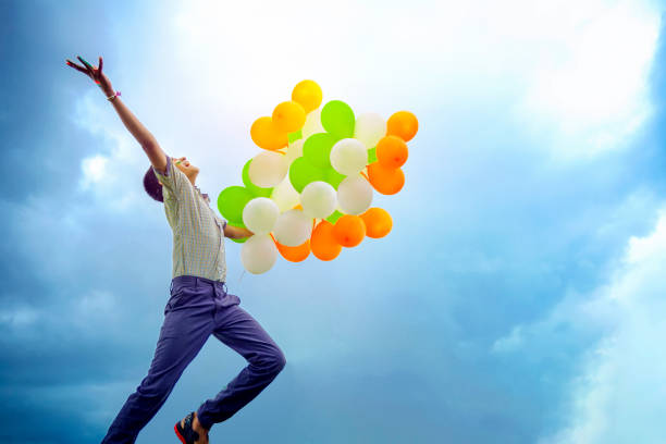 little indian school boy jumping in sky with tri color balloons and celebrating independence or republic day of india - day asian ethnicity asian culture asian and indian ethnicities imagens e fotografias de stock