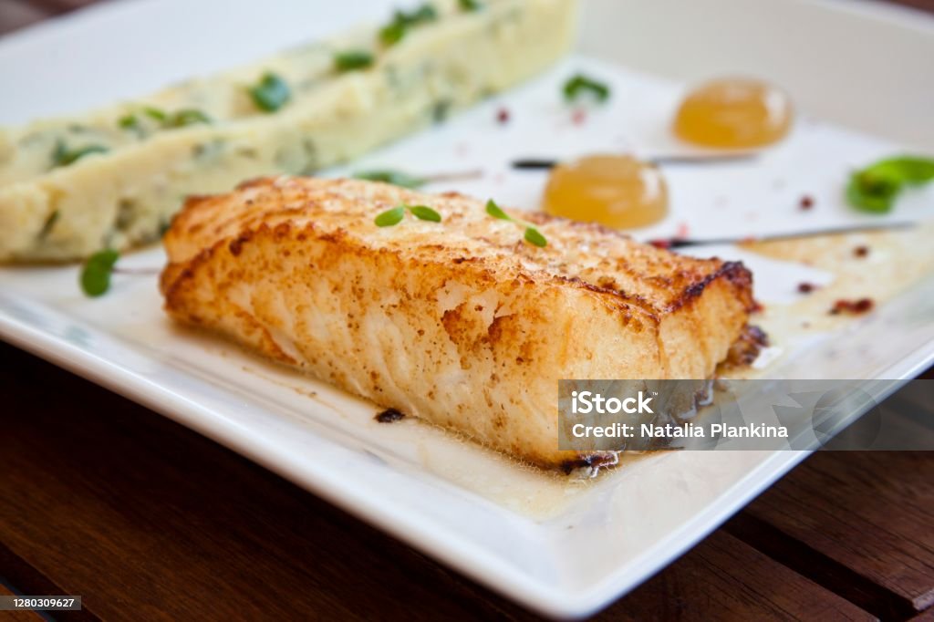 grilled juicy steak fish Seabass steak. Garnish - mashed potatoes. Close-up Sea Bass Stock Photo