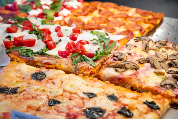 istock Variety of pizza al taglio displayed in takeout 1280309630