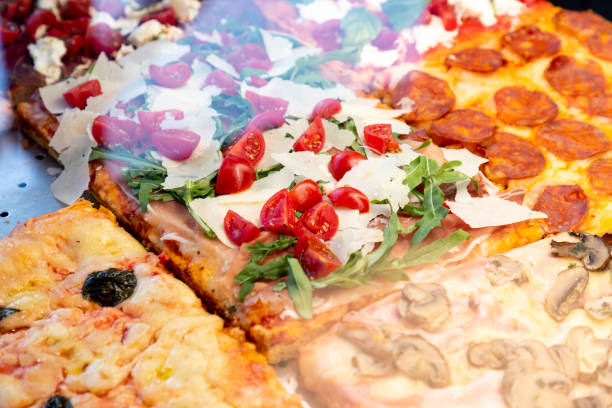 istock Focus on pizza al taglio with grana, arugula and cherry tomato in showcase 1280309676