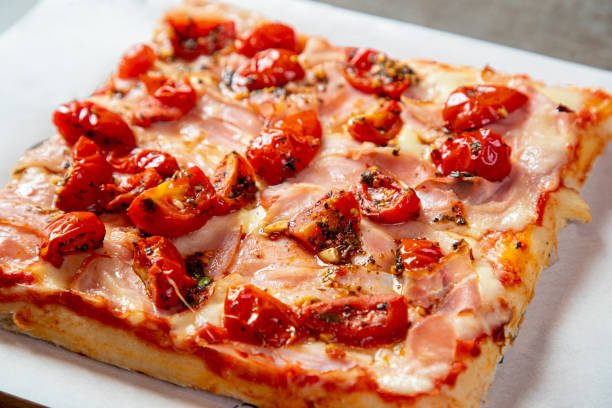 istock Pizza slice with chopped cherry tomato, basil, parmesan cheese and ham 1280309719