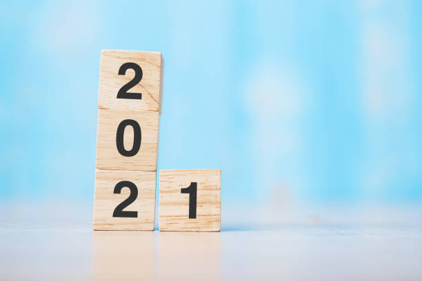 istock 2021 wooden cube block on table background. Resolution, strategy, solution, goal, business and New Year holiday concepts 1280310354