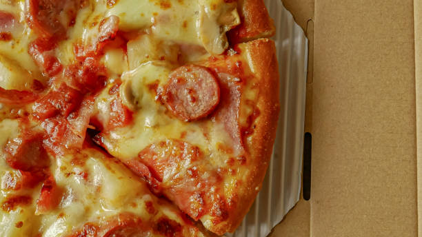 istock pizza in paper box  close up image for food content. 1280312377