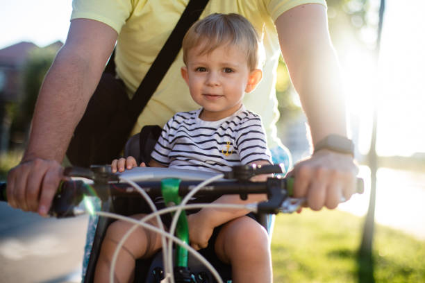 istock Father riding the bicycle with son in the seat 1280313991