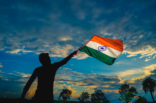 India flag being waved by a man , celebrating Independence or Republic day of India