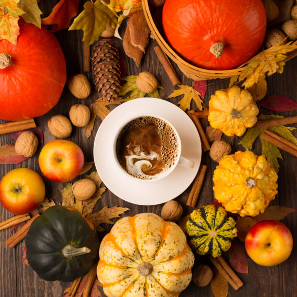 istock Autumn composition with cup of coffee, pumpkins, apples, nuts and cinnamons on dark rustic wooden background. 1280315075