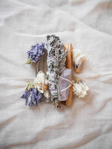 Sage bundle with crystals and flowers Sage bundle with crystals and dried purple flowers. crystal altar stock pictures, royalty-free photos & images