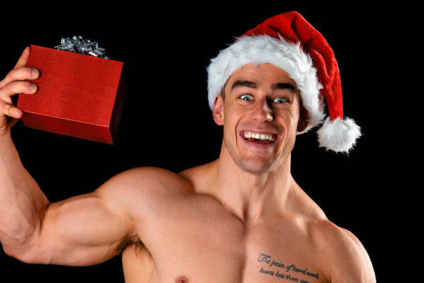 muscular male with christmas gift - shirtless men bizarre male imagens e fotografias de stock