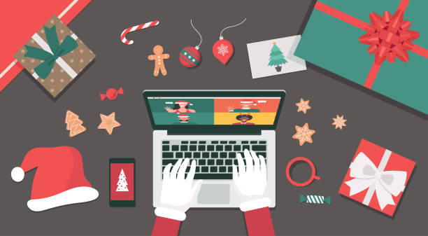 istock Concept of Santa Claus hand using a laptop video call to people on top view table 1280316730