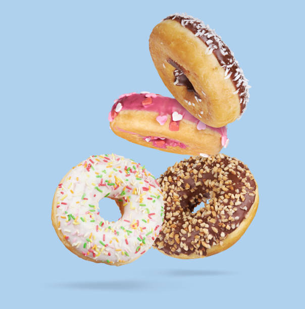 istock Mix of flying multicolored sweet donuts with sprinkles on blue background 1280319149
