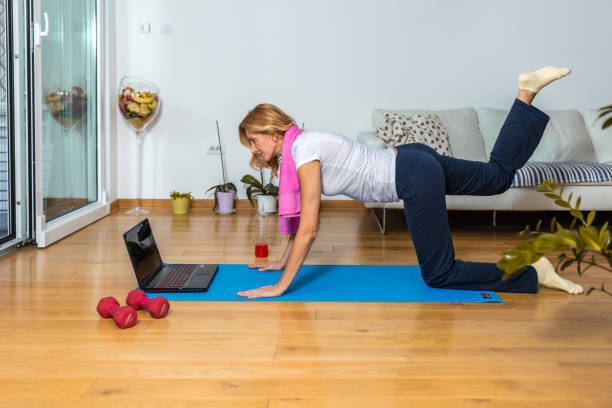 istock Female doing exercise in her living room. 1280319361