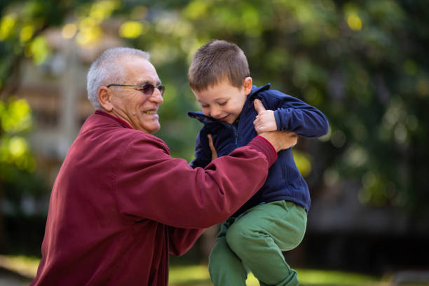 istock Grandtafher throws up his grandson 1280319653