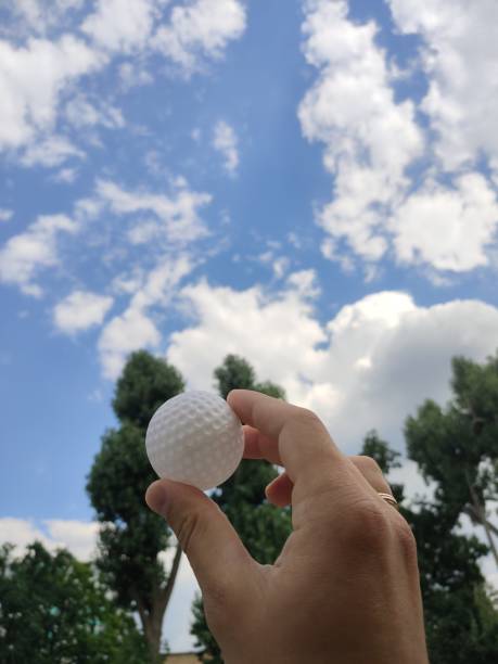 istock golf ball in a man's hand in nature 1280319750