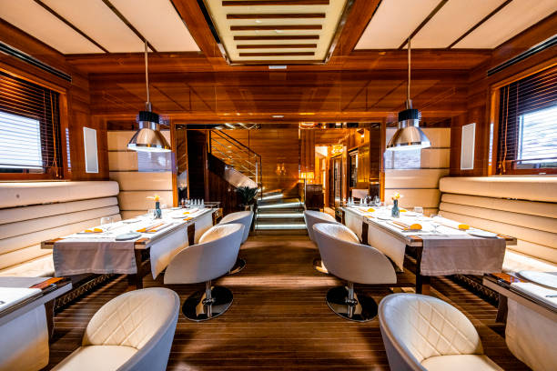 two rows of tables in a high profile restaurant - dining nautical vessel recreational boat europe imagens e fotografias de stock