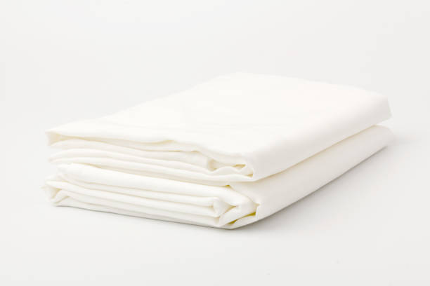 Stack of clean bed sheets on white  background, closeup. Stack of clean bed sheets on white  background, closeup. sheet stock pictures, royalty-free photos & images