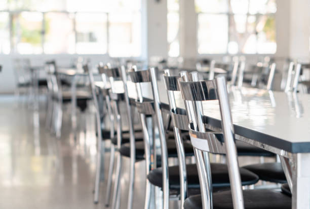 istock Stainless steel tables and chairs in high school student canteen 1280321919