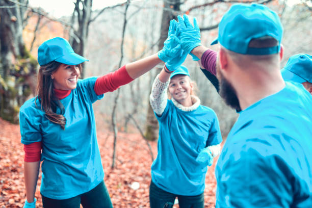 istock High Five By Smiling Volunteers After Cleaning Garbage From Forest 1280322003