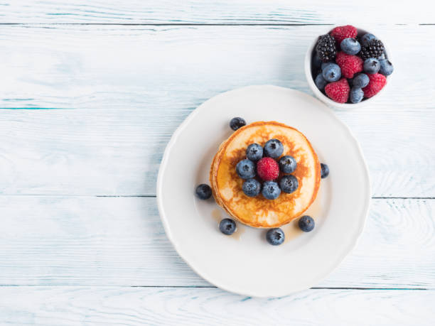 istock Stack of pancakes with blueberries and syrup 1280322337