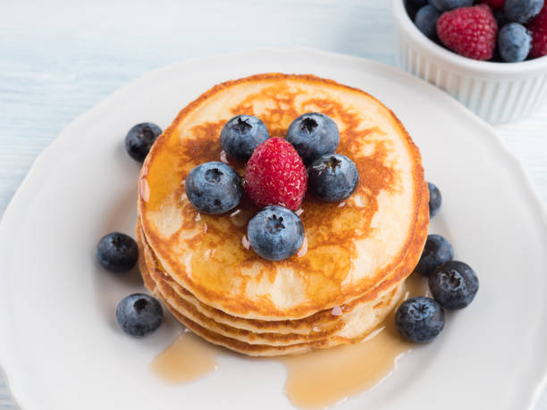 istock Stack of pancakes with blueberries and syrup 1280322338